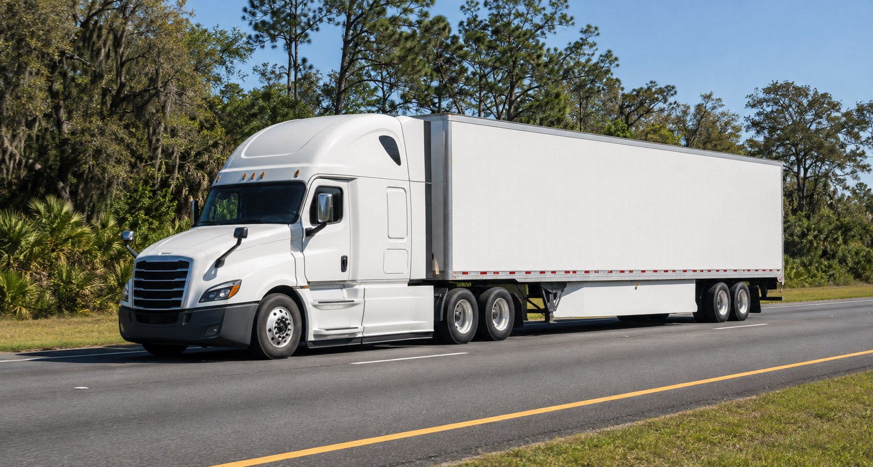 An unbranded white semi-truck traveling on a green Florida highway